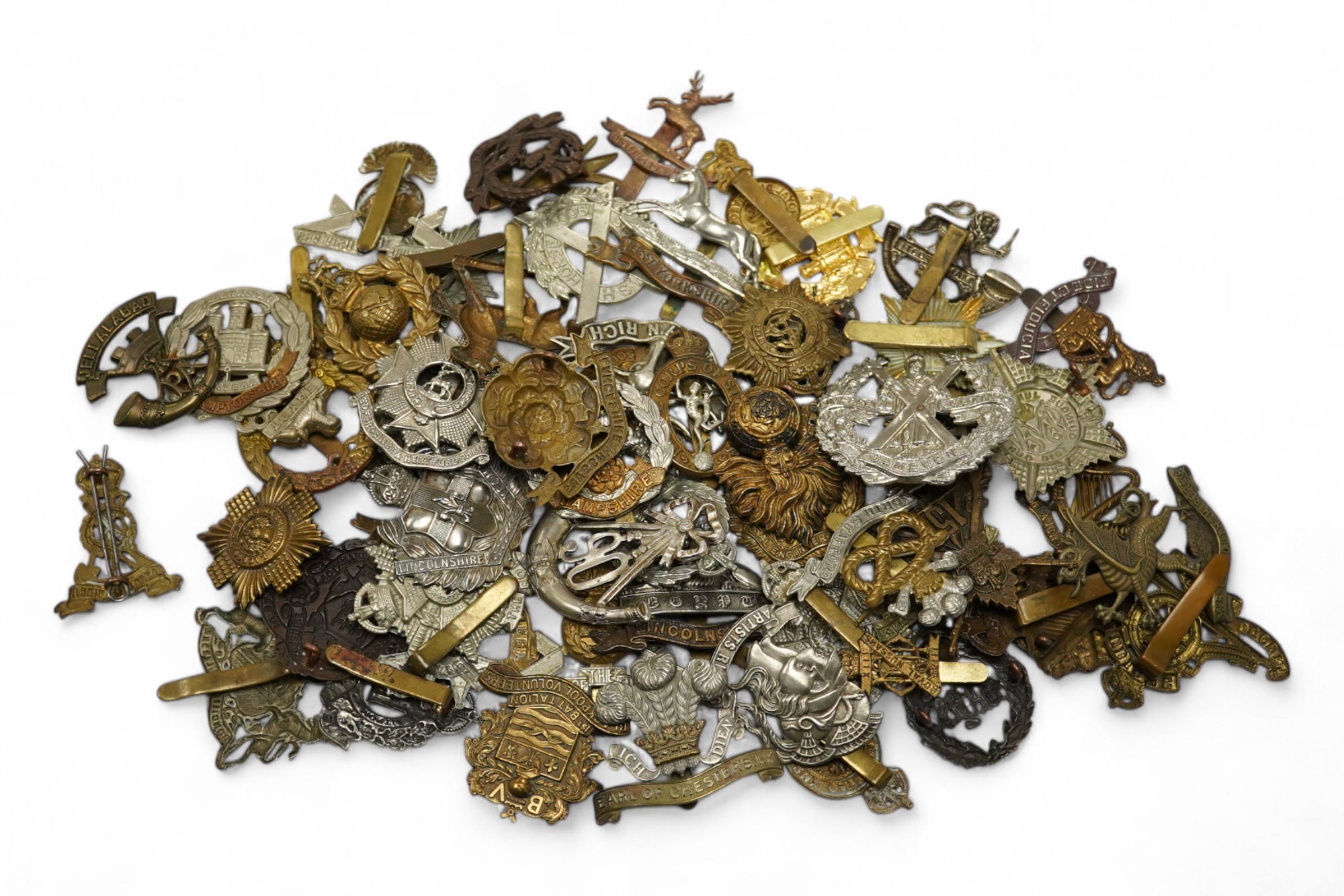 Sixty military cap badges including; the Lancashire Hussars, the Royal Corps of Signals, the Essex Regiment, the Royal Engineers, the North Stafford Regiment, the Border Regiment, the Glamorgan Yeomanry, etc. Condition f